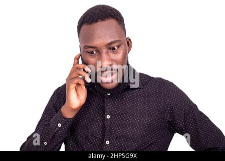 portrait of a handsome serious young man talking on cellphone. Stock Photo