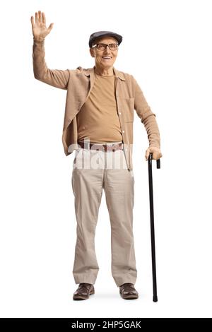 Elderly gentleman standing with a cane and waving isolated on white ...