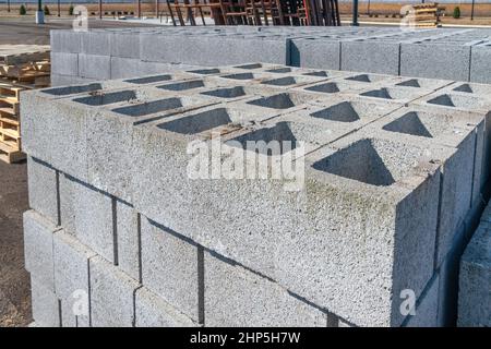 Horizontal shot of stacks of cinder blocks and other building materials at a construction site. Stock Photo