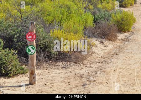 Information signs on wooden post along tourists footpath in flamingo area at Al Wathba Wetland Reserve in Abu Dhabi, UAE Stock Photo