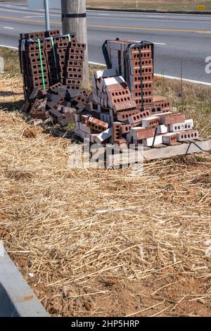 Vertical shot of bundles of bricks at a new construction site. Stock Photo