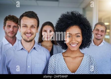 Confidence stands with this team. Portrait of a confident group of businesspeople standing in an office. Stock Photo