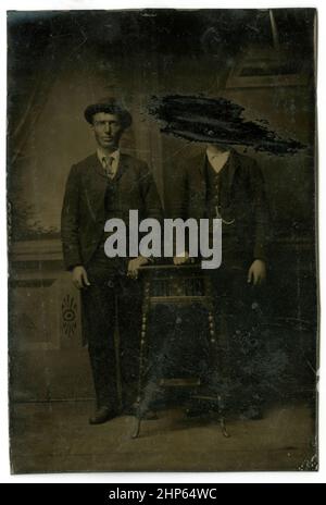 Antique circa 1860 tintype photograph, two men, one of whom has been scratched out. Location unknown, USA. SOURCE: ORIGINAL TINTYPE Stock Photo