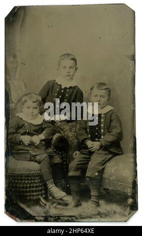 Antique circa 1860 tintype photograph, three young children probably siblings. Location unknown, USA. SOURCE: ORIGINAL TINTYPE Stock Photo