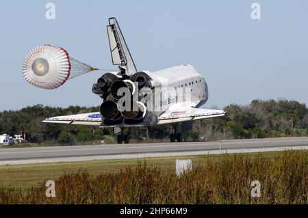 With drag chute unfurled, space shuttle Discovery lands on Runway 33 at ...