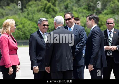 Vice President Mike Pence, back to the camera, is greeted by NASA officials at the Shuttle Landing Facility at NASA's Kennedy Space Center in Florida. From the left are, Deputy Center Director Janet Petro, Center Director Bob Cabana and Acting Administrator Robert Lightfoot. To the right of Lightfoot is Sen. Marco Rubio of Florida. During his visit to Kennedy, the Vice President spoke inside the iconic Vehicle Assembly Building, where he thanked employees for advancing American leadership in space. Stock Photo