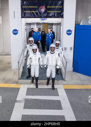 ESA (European Space Agency) astronaut Thomas Pesquet, back left, NASA astronauts Megan McArthur, front left, and Shane Kimbrough, front right, and Japan Aerospace Exploration Agency (JAXA) astronaut Akihiko Hoshide, back right, wearing SpaceX spacesuits, are seen as they prepare to depart the Neil  A. Armstrong Operations and Checkout Building for Launch Complex 39A to board the SpaceX Crew Dragon spacecraft, Friday April 23, 2021, at NASA’s Kennedy Space Center in Florida. Stock Photo