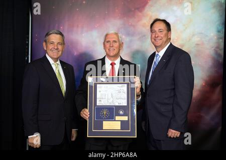 Kennedy Space Center Bob Cabana, left, and NASA's Acting Administrator Robert Lightfoot, right present Vice President Mike Pence with a framed plaque. At the top is an illustration featuring NASA's efforts to explore Mars. Also included is the flag of the Vice President's home state of Indiana that was flown on the SpaceX Commercial Resupply Services-10 flight in February and March this year. During his visit to Kennedy, the Vice President spoke inside the iconic Vehicle Assembly Building, where he thanked employees for advancing American leadership in space. Stock Photo