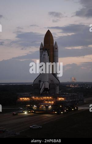Space Shuttle Atlantis rolls out to Launch Pad 39A on a moon light ...