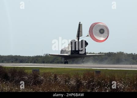 With drag chute unfurled, space shuttle Discovery lands on Runway 33 at ...