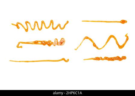 Orange apricot jam splashes isolated on white background. Top view. Stock Photo