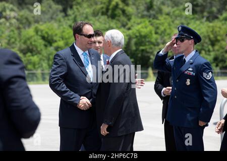 NASA's Acting Administrator Robert Lightfoot, left, greets Vide President Mike Pence at the Shuttle Landing Facility at the agency's Kennedy Space Center in Florida. During his visit to Kennedy, the Vice President spoke inside the iconic Vehicle Assembly Building, where he thanked employees for advancing American leadership in space. Stock Photo