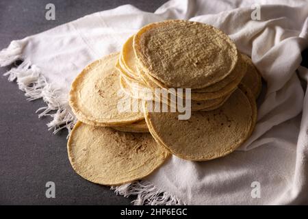 Corn Tortillas. Food made with nixtamalized corn, a staple food in several American countries, an essential element in many Latin American dishes. Stock Photo