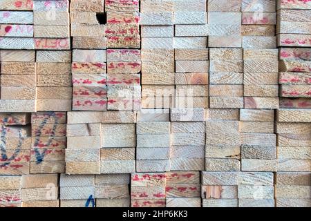 Industrial heads wood rectangle shape of sawed timber material that are stacked in a square on wood warehouse store, wood texture and background Stock Photo