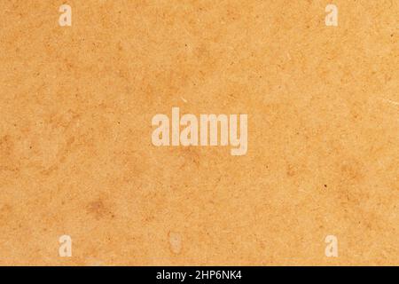 Pressed brown grunge paper with dirty spots. Abstract background. Aged cardboard Stock Photo