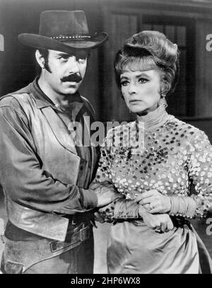 Photo of Amanda Blake as Miss Kitty and Pernell Roberts guest-starring as a hired gunfighter from the television series Gunsmoke Stock Photo