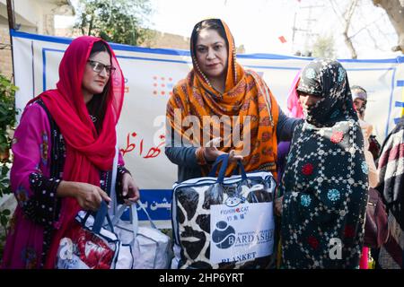 HARNAI-PAKISTAN, Feb 18-2022: Chairperson national commission on the status of women Mrs. Nelofer Bakhtiar distributing blanket among the earthquake effected women in Harnai District. Stock Photo