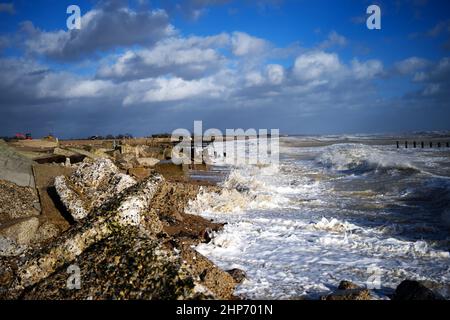 Climping Beach in West Sussex, Southern England on the English Channel with waves braking on the rocks after Storm Eunice and old sea defences. Stock Photo