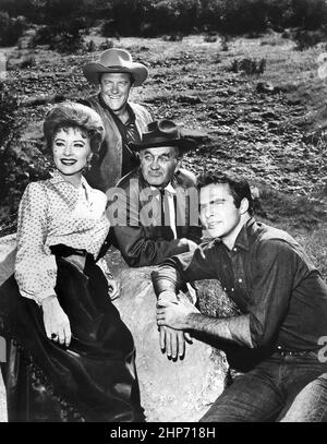 Photo of the main cast for the television program Gunsmoke in 1963.  From left: Amanda Blake (Miss Kitty), James Arness (Matt Dillon), Milburn Stone (Doc Adams), and Burt Reynolds (Quint Asper) Stock Photo