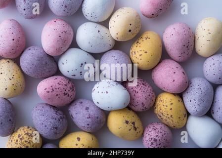 Colorful speckled mini Easter eggs on a plain back ground shot from above, flat lay Stock Photo