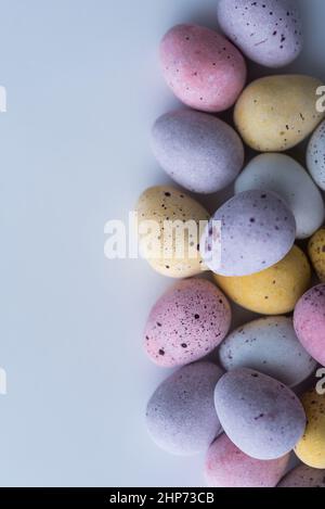 Colorful speckled mini Easter eggs on a plain back ground shot from above, flat lay Stock Photo