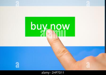 A woman's finger doing some online shopping from her touchscreen tablet.The images on the screen are produced by me Stock Photo