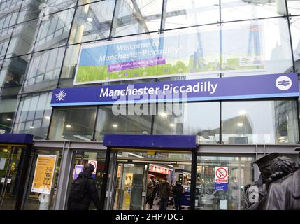 Manchester, UK, 19th February, 2022. People enter Piccadilly Station, Manchester, UK. Trains are cancelled and delayed from Manchester, England, United Kingdom, British Isles in the wake of Storm Eunice. There are no trains from Manchester to Preston where storm Eunice damaged the roof of the station. Network Rail staff are checking train lines for fallen trees and damage. Public transport across Europe has been affected by the storm. Credit: Terry Waller/Alamy Live News Stock Photo