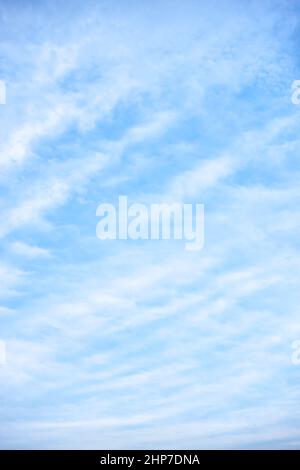 Light-blue sky with white clouds - vertical background Stock Photo