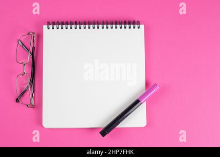 Open notepad with blank page on desktop, top view. Stock Photo