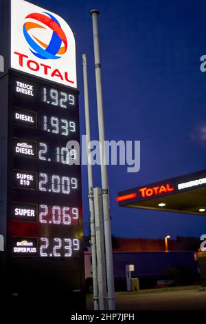 Denkendorf, Germany - February 19, 2022: Close up of price display in front of gas station at night. High and expensive fuel prices in europe. Total. Stock Photo