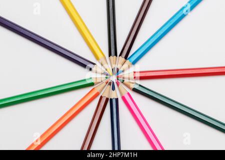 Clipped colorful crayons lined up side by side on white background. Stock Photo
