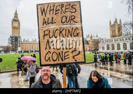 London, UK. 19th Feb, 2022. A small United Against Johnson protest on Parliament Square in pouring rain. Organised by the collective Take Back Democracy, the protest comes in the wake of scandals over Downing Street parties and second jobs. Credit: Guy Bell/Alamy Live News Stock Photo