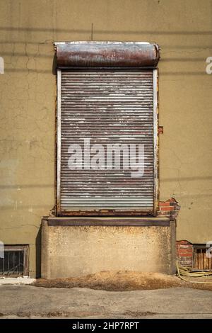 Roller shutter on an abandoned industrial building.  Ottawa, Illinois, USA. Stock Photo