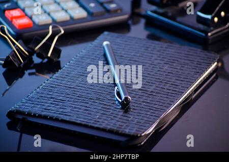 Black leather notebook and pen in the workplace Stock Photo