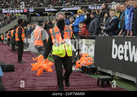 London, UK. 19th Feb, 2022. A match day steward removes inflatable cats thrown by Newcastle fans during the West Ham vs Newcastle Utd Premier League match at the London Stadium Stratford. Credit: MARTIN DALTON/Alamy Live News Stock Photo