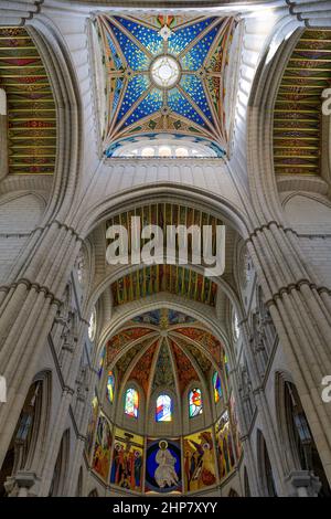 Almudena Cathedral - Vertical interior view of square cupola and colorful ceiling vault above main altar of Almudena Cathedral, Madrid, Spain. Stock Photo