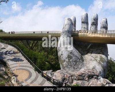 Da Nang, Vietnam - April 12, 2021: Golden Bridge lifted by giant hands in Ba Na Hills, a famous theme park and resort in Central Vietnam Stock Photo