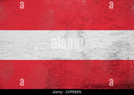 Full frame photo of a weathered flag of Austria painted on a plastered brick wall. Stock Photo