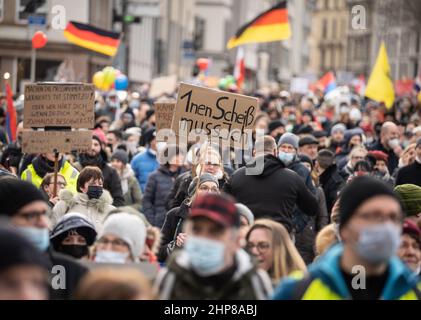 19 February 2022, Hessen, Frankfurt/Main: A woman carries a placard reading '1nen Scheiß muss ich' during a demonstration of several thousand people against corona measures and compulsory vaccination in downtown Frankfurt. Photo: Frank Rumpenhorst/dpa Stock Photo