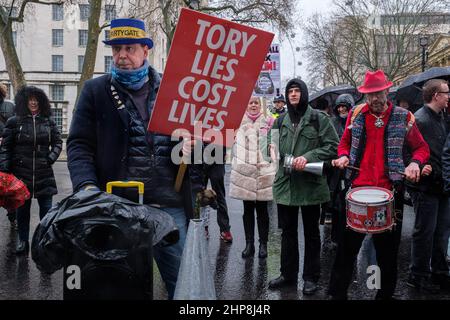 London, UK. 19th February, 2022. Protest against British Prime Minister Boris Johnson and his government by the group Take Back Democracy. “Tory Lies Cost Lives” is read in multiple signs. Credit: Joao Daniel Pereira Stock Photo