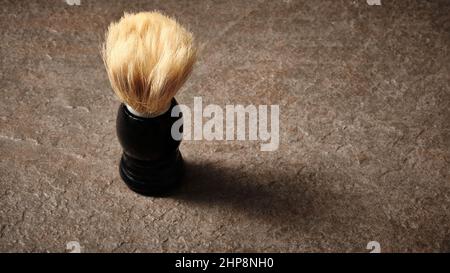 Shaving brush on stone countertop Stock Photo