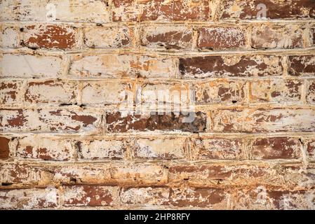 Old brick wall smeared with paint Stock Photo