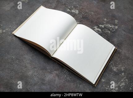 Blank opened brochure on concrete background. Mock-up for graphic designers portfolios. Stock Photo