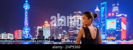 Shanghai woman travel China Luxury lifestyle of the rich chinese millionaires. Asian elegant lady going out in city nightlife looking at skyline vew Stock Photo