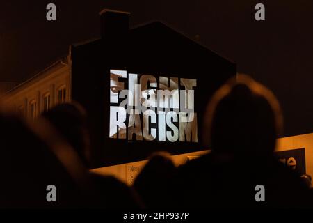 19 February 2022, Hessen, Frankfurt/Main: 'Fight Racism' with the faces of the victims is written on a house facade at the Camberger Bridge in memory of the victims of the racially motivated attacks of Hanau in 2020. The artists' collective 'Kollektiv ohne Namen' carried out the action. Photo: Hannes Albert/dpa Stock Photo