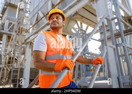Skillful multiethnic engineer working on construction site Stock Photo