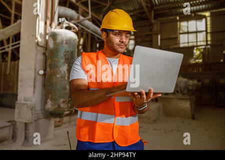 Skillful multiethnic engineer working at construction plant Stock Photo