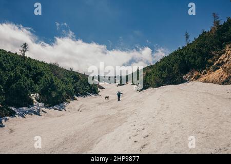 A group of people walking down a dirt road Stock Photo