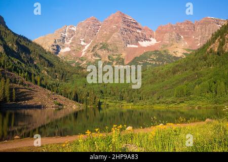 Maroon Bells, crystal clear lake and beautiful summer reflections in early morning near Aspen, Colorado Stock Photo