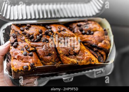 Golden baked babka famous Jewish pastry made with chocolate chips and challah bread dough storebought with plastic package Stock Photo